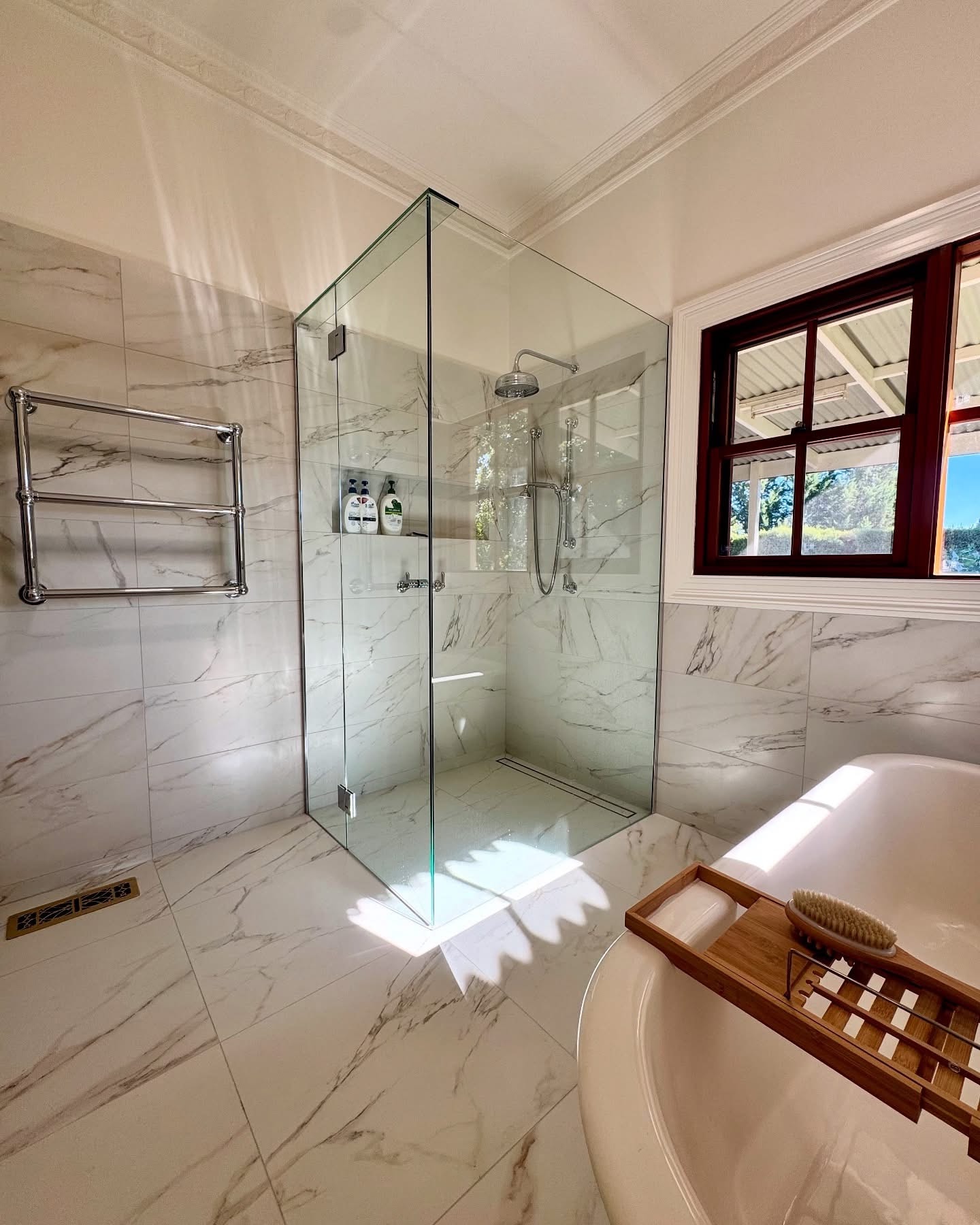 Spa bathroom with warm wood accents and white fixtures