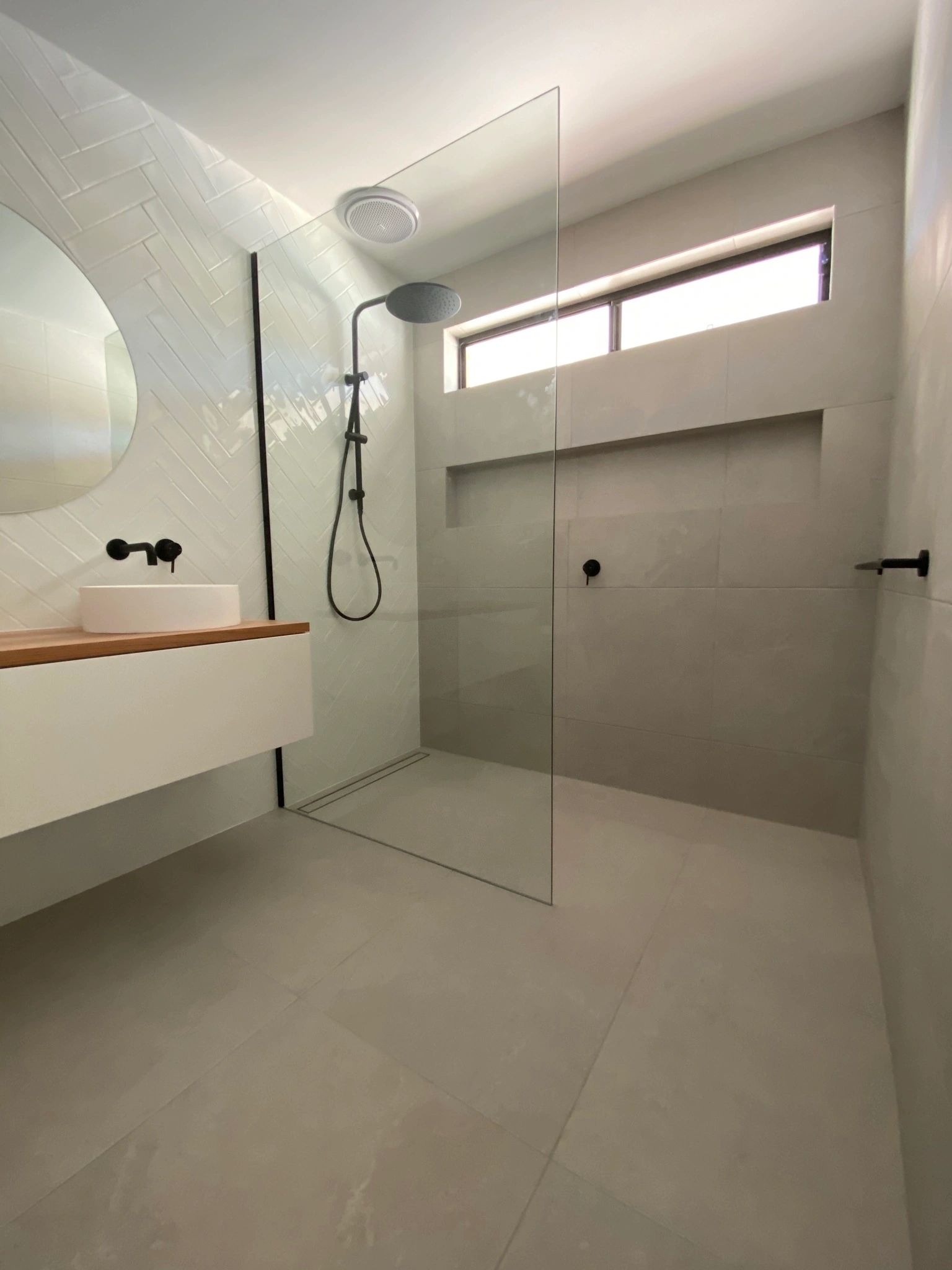Bathroom renovation detail showing modern vanity and window